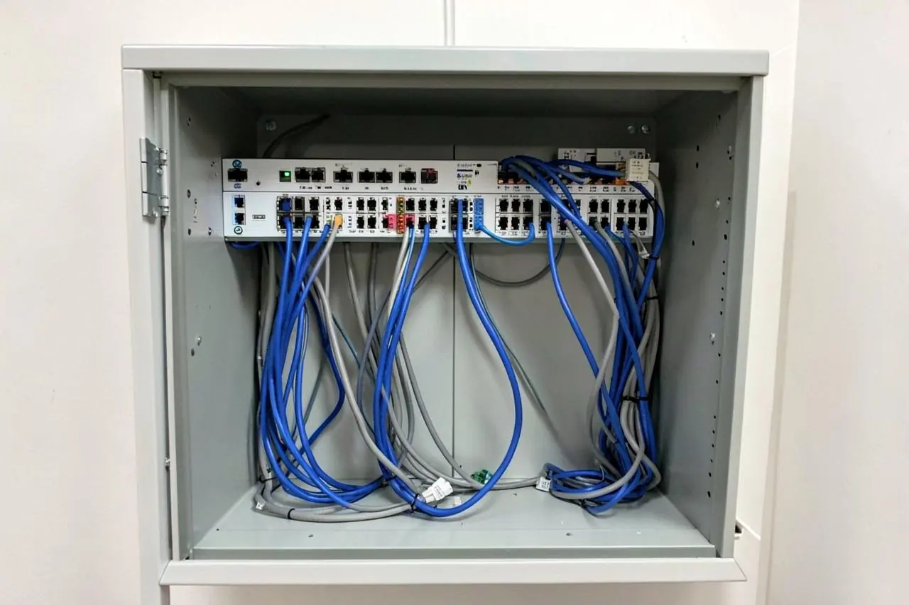 Neatly dressed network patch panel and switch in a small wall cabinet