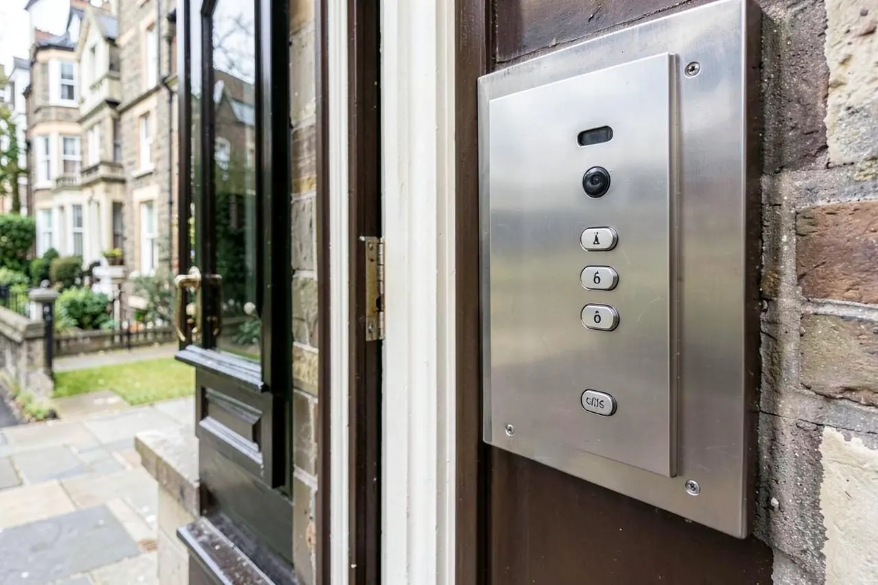 Stainless steel video door entry panel beside the front door of a London mansion block