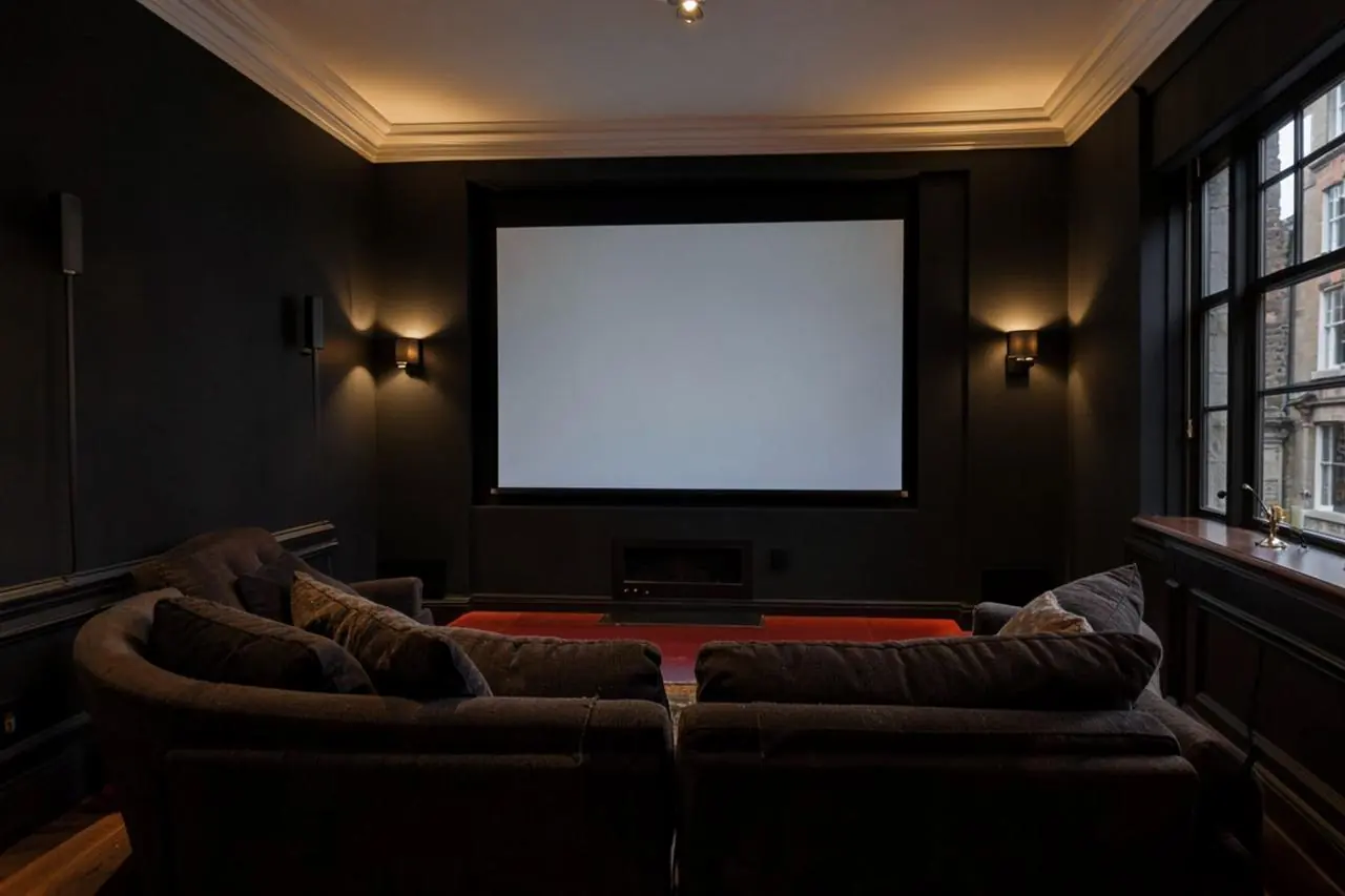 Home cinema room in a London period house with a large screen and discreet speakers