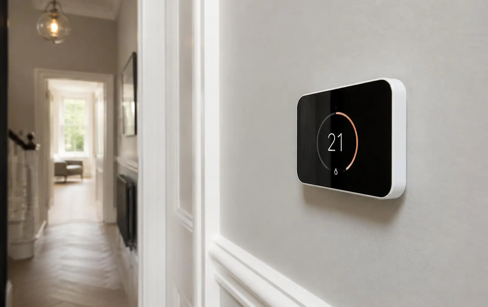 Modern smart heating control panel on a hallway wall in a London home
